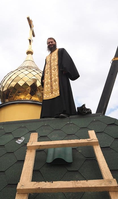Протоиерей Игорь Фомин во время установки купола на временный храм